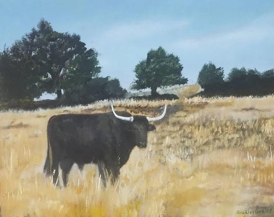 Painting of a black steer with white horns, looking at the viewer. The bull is standing in an amber meadow with green trees and shrubbery in the background.